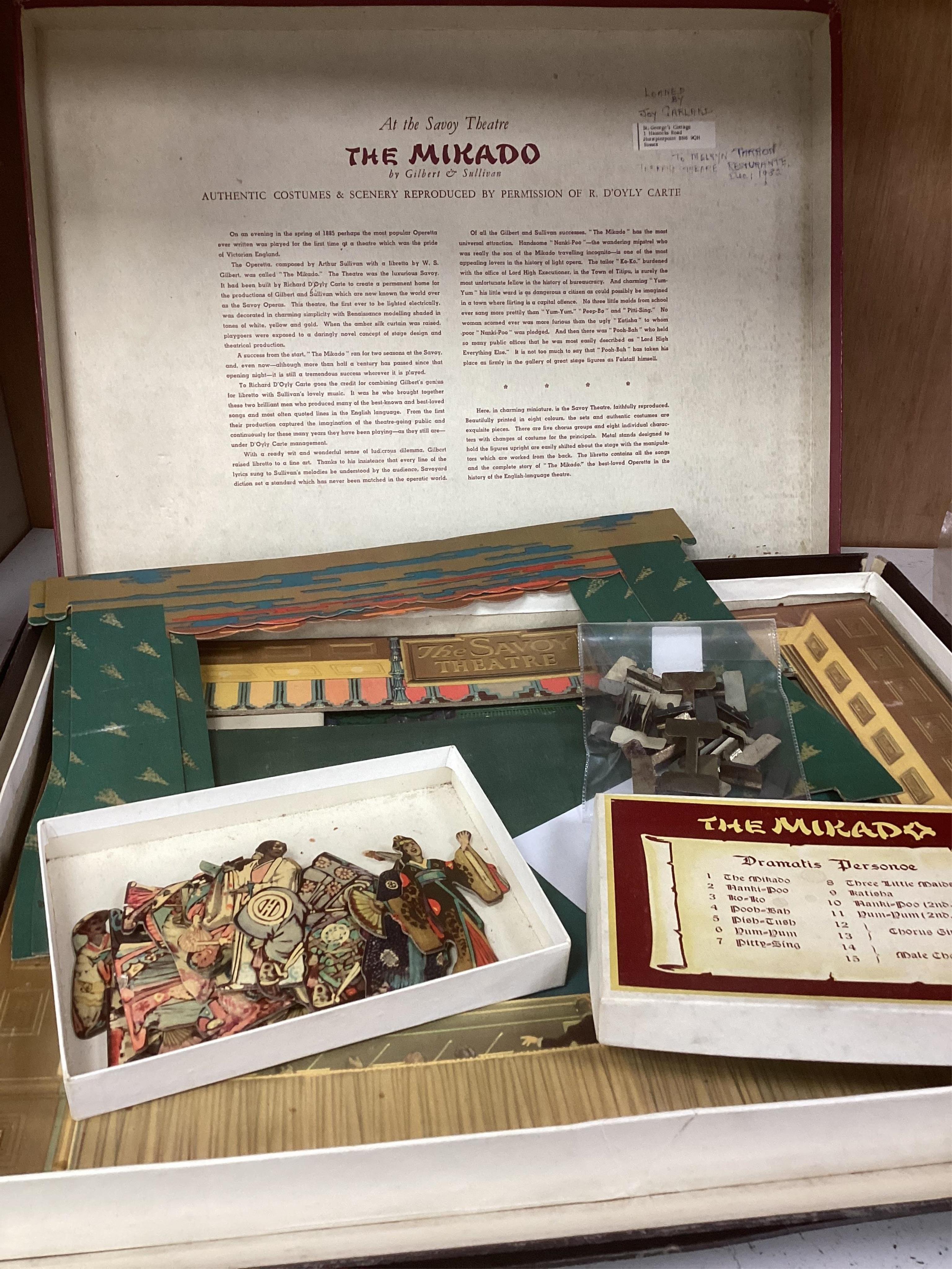 A Gilbert and Sullivan Opera model theatre, with printed card figures from the Mikado, together with a portrait photograph of Sir Arthur Sullivan loosely contained within a stained wood frame, the photograph is unmounted